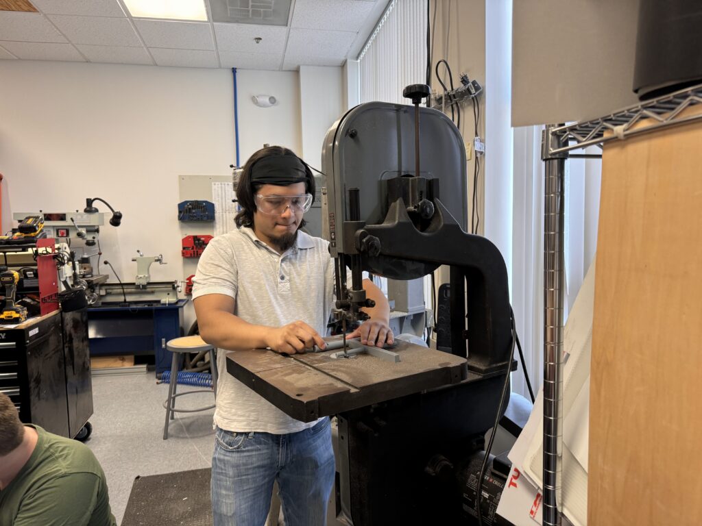 Building Speed: Inside Goddard’s Design Challenge 1 Engineer with bandsaw
